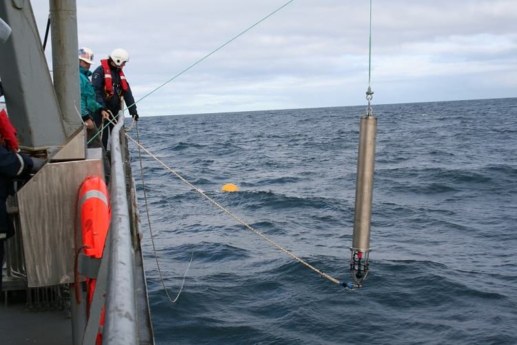 A hydrophone being lowered into the sea.